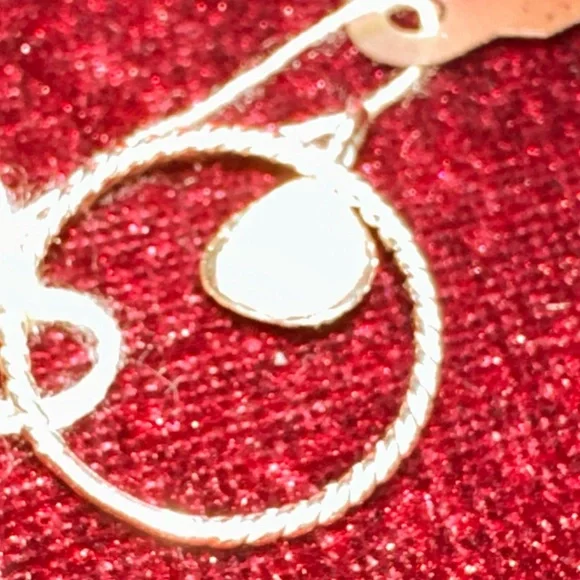 14 karat yellow gold cable ring with a beautiful shell hanging